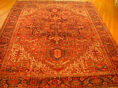 Lot 185 - A Heriz carpet, the red field with large...