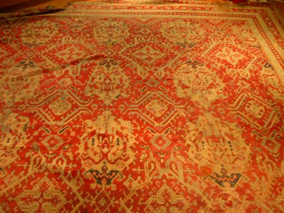 Lot 186 - An Ushak carpet, the madder red field with...