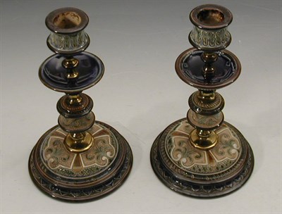 Lot 136 - A matched pair of Doulton Lambeth candlesticks...