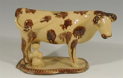 Lot 37 - An English treacle sponge decorated cow creamer
