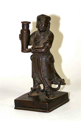 Lot 177 - A Chinese bronze figure of a man holding a vase<br/>Ming Dynasty