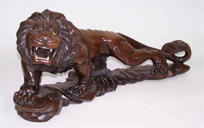 Lot 202 - A Chinese hardwood roaring lion ALTERATION not Japanese